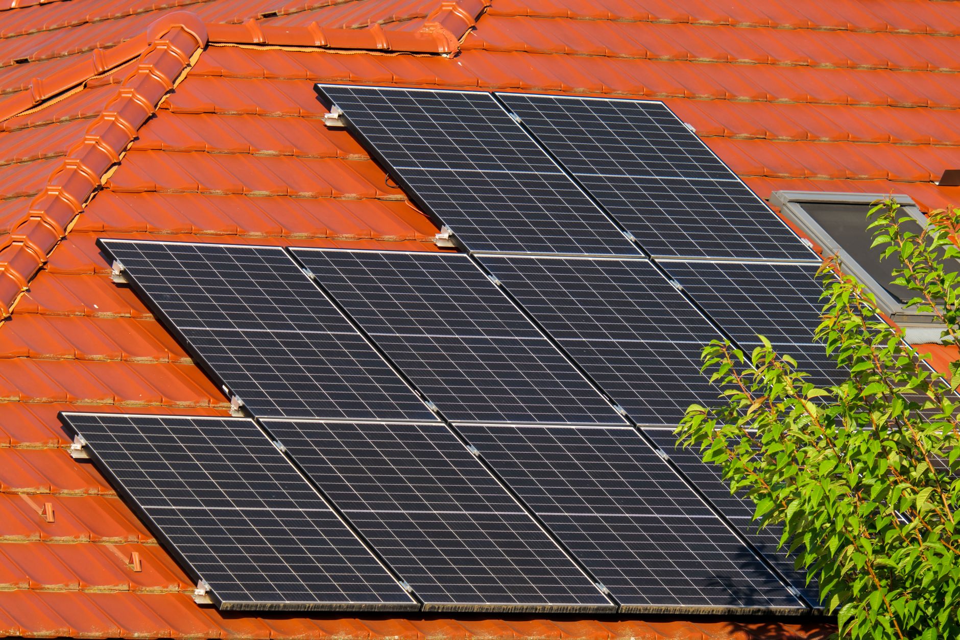 A microinverter attached to a solar panel on a residential roof