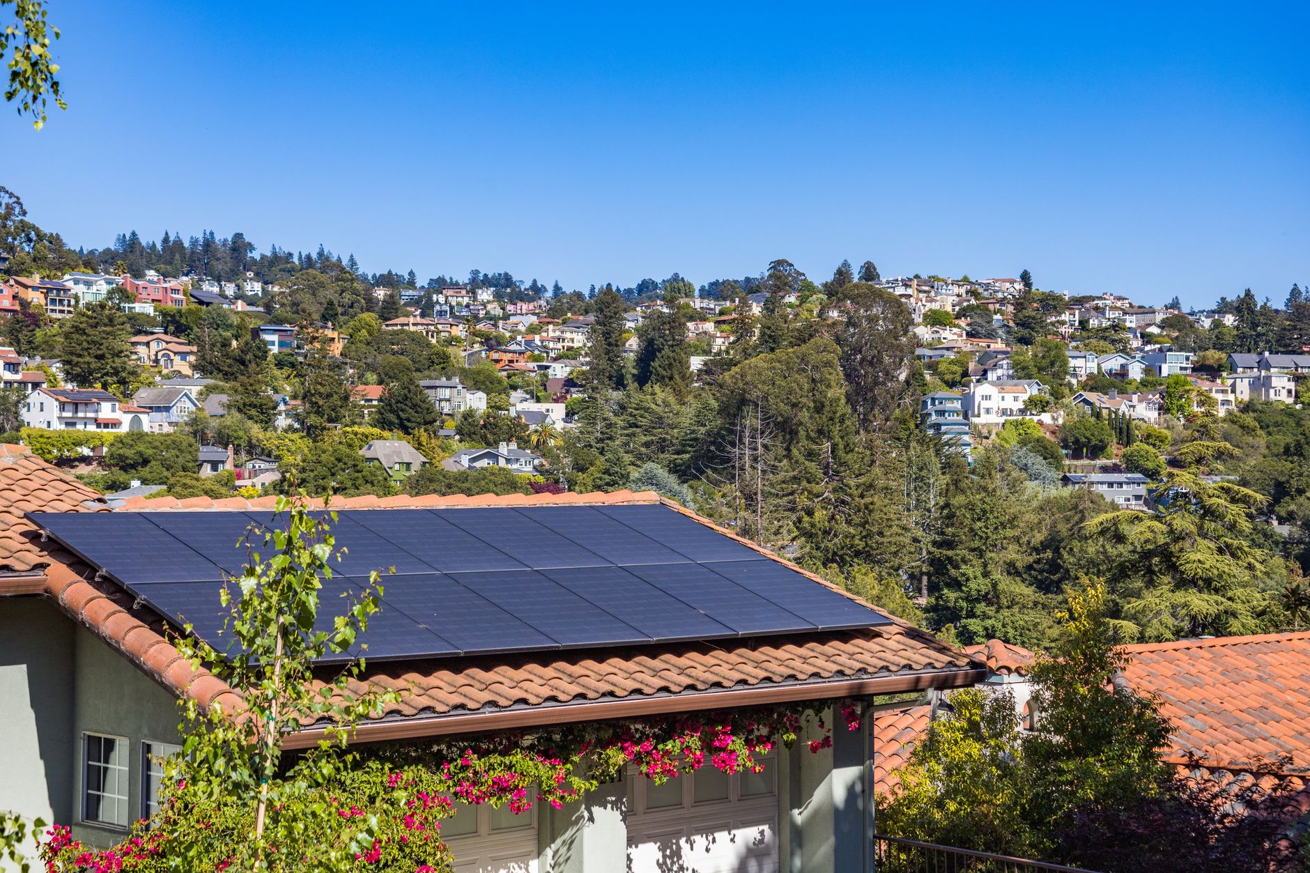solar panels installed on a suburban roof under a clear sky