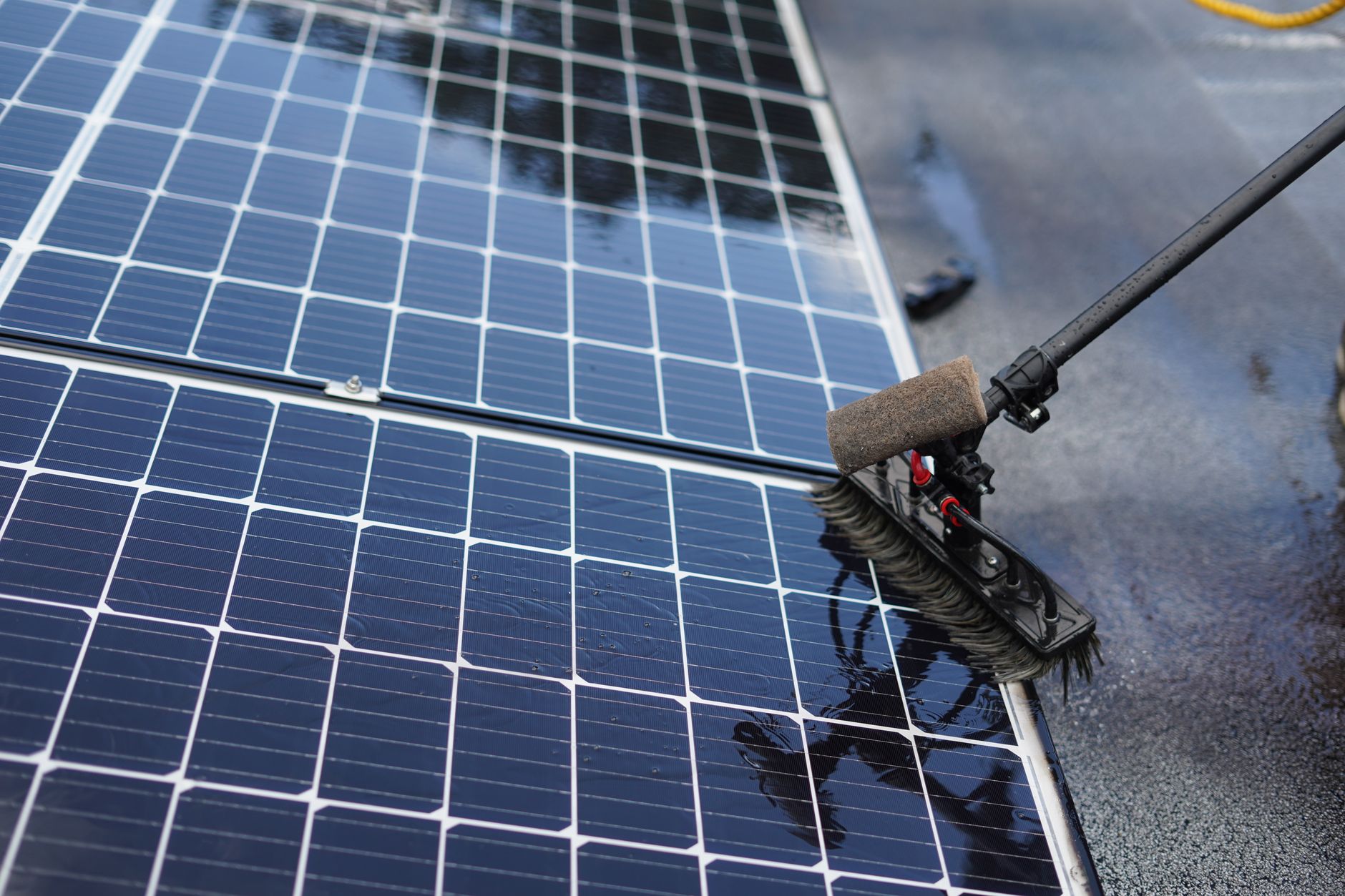 Rigid solar panel mounted on the roof of a white recreational vehicle