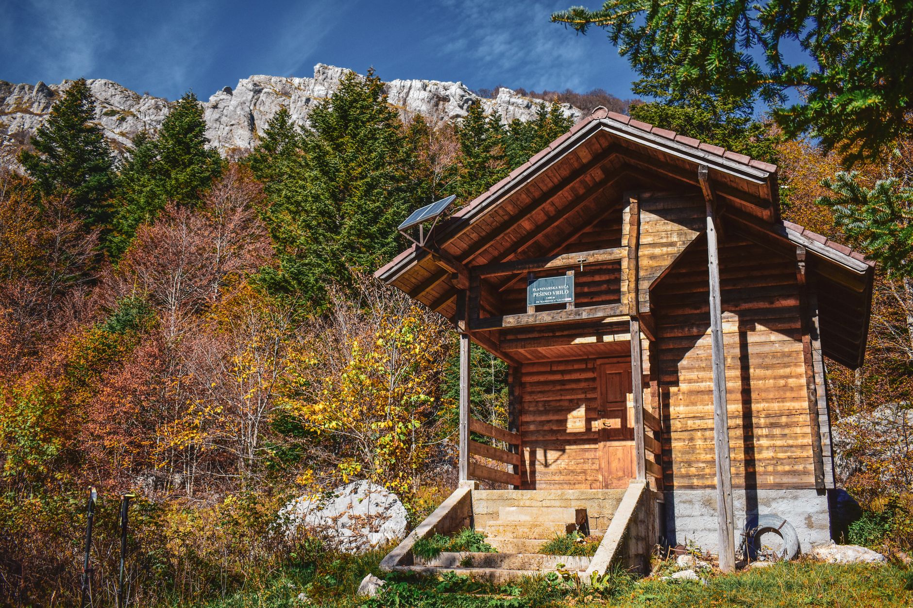 Portable EcoFlow battery power station with solar panels outside a wooden cabin