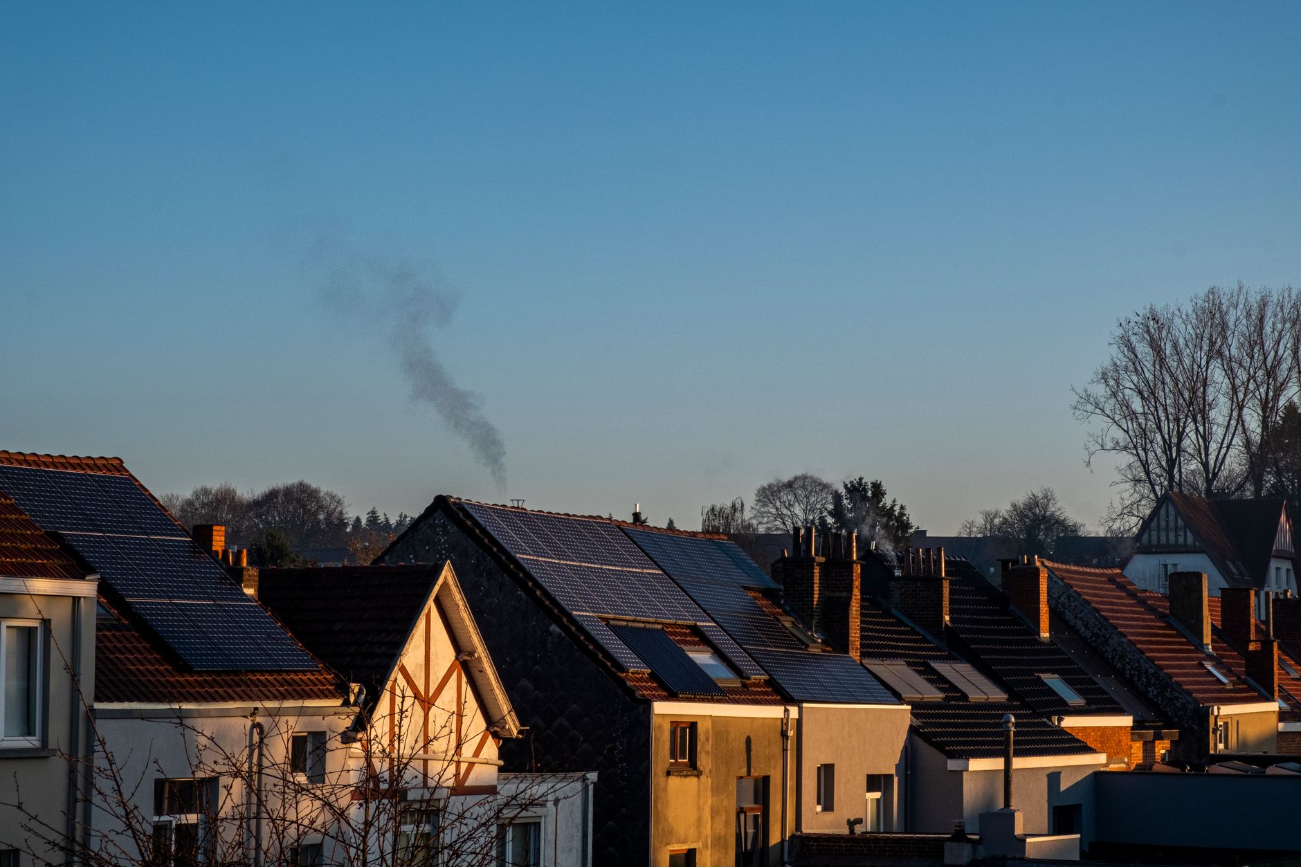 rooftop solar panels installed on a house roof under a clear sky